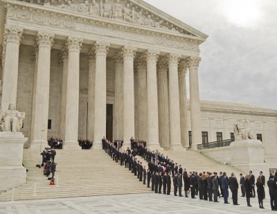 The casket containing the body of Justice Antonin Scalia, who passed away over the weekend, is carried into the Supreme Court to lie in repose on Feb. 19, 2016, before his burial tomorrow in Washington, D.C. His former law clerks served as honorary pallbearers. (Tom Williams/Congressional Quarterly/Newscom/Zuma Press/TNS)