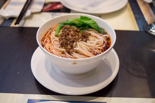 Dan Dan Noodles with gailan vegetable and small scoop of diced meat on top is a must at Meizhou Dongpo. (L. Xu)