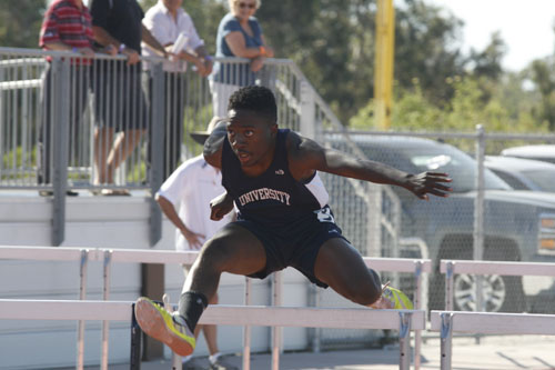 Sprinting the 110 meter hurdles, Morais Burge (Sr.) competes for a fast finish. (A.Li)