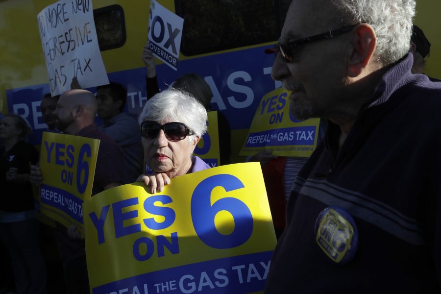 Moni Hatchikian, center, and others  at a Yes on Prop. 6 rally on Oct. 18, 2018 in Burbank, Calif. Proposition 6 is on the November ballot and would repeal the states new gas tax and vehicle license fee. (Irfan Khan/Los Angeles Times/TNS)