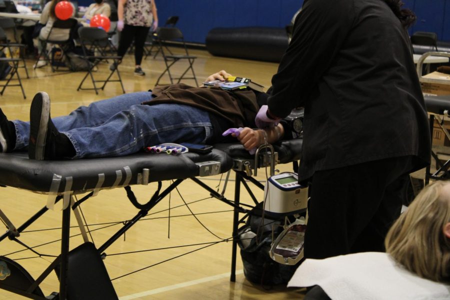 A student gets ready to have their blood drawn in the Small Gym. 