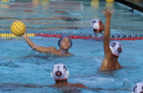 University Varsity Water Polo player passes the ball to his teammate against Beckman at University High School home game. 