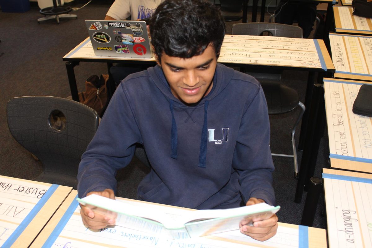 Rishi Raja studies from a World History textbook in Mrs. King’s classroom during office hours. 
