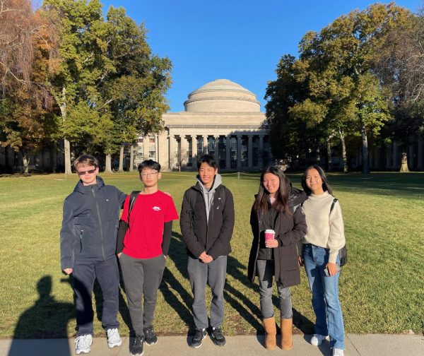 UHS Science Bowl team members stand in front of the Massachusetts Institute of Technology (MIT) campus for a group photo. 