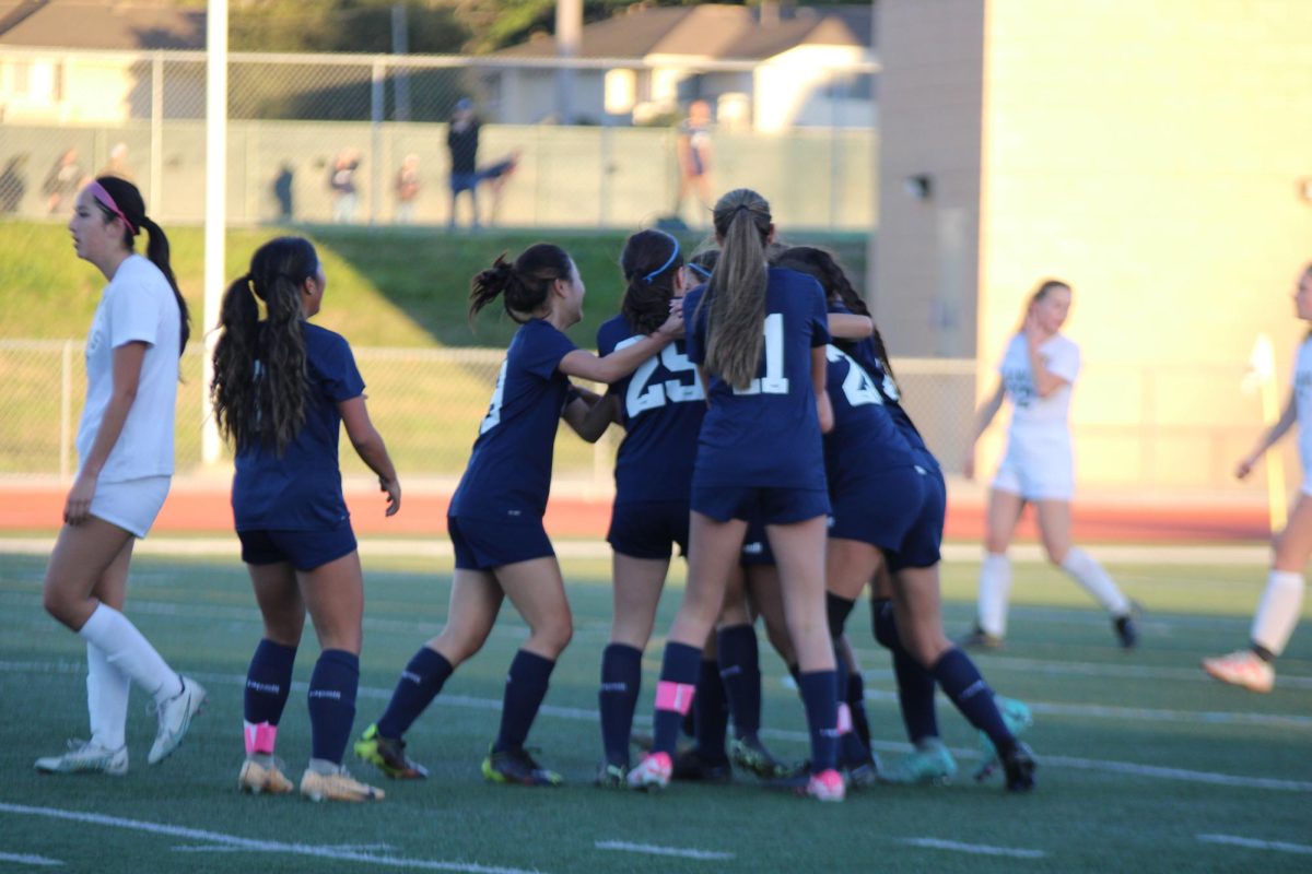 The+UHS+Girls+Varsity+Soccer+Players+celebrate+a+goal.+Freshman+Ayla+Agahi+scored+a+goal+during+an+intense+moment+in+the+game%2C+giving+her+team+a+further+advantage+in+the+game.+