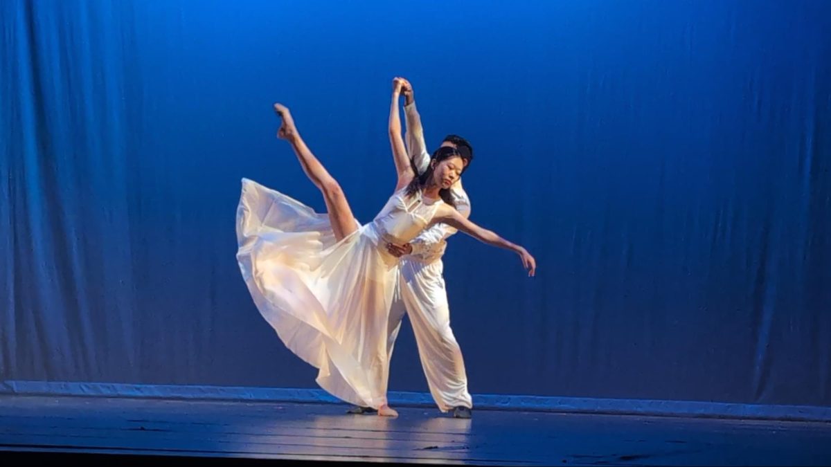 Sharon Kim performs a développé with the support of Miles Martinez during the performance of “Unraveling Desire” based on the novel, Anna Karenina on April 19 in the UHS Big Theater.