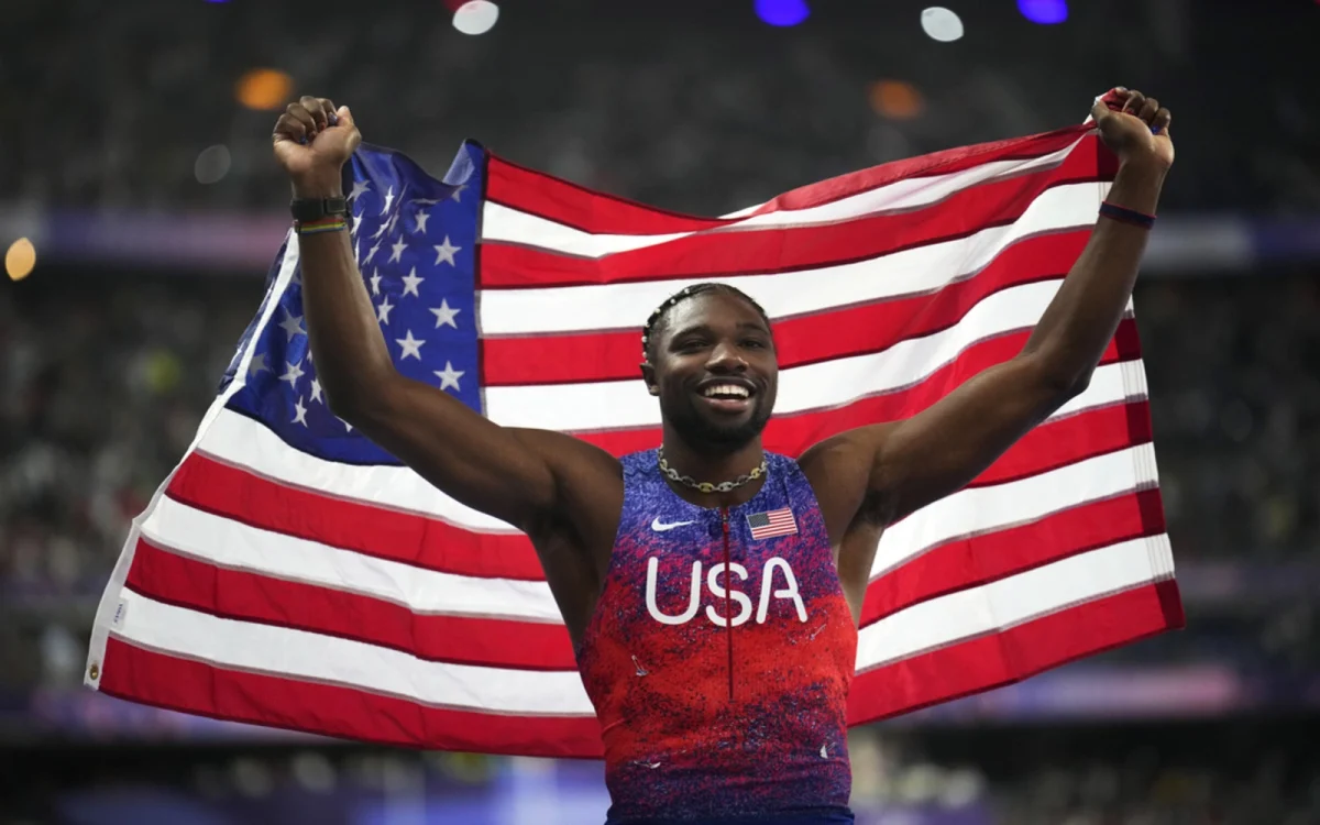 Olympian Noah Lyles celebrating after winning the 100-meter gold at the 2024 Paris Olympics.