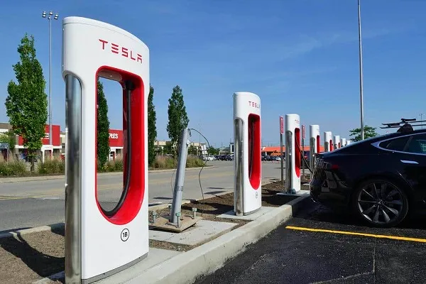 A row of EV charging stations at a gas station. 