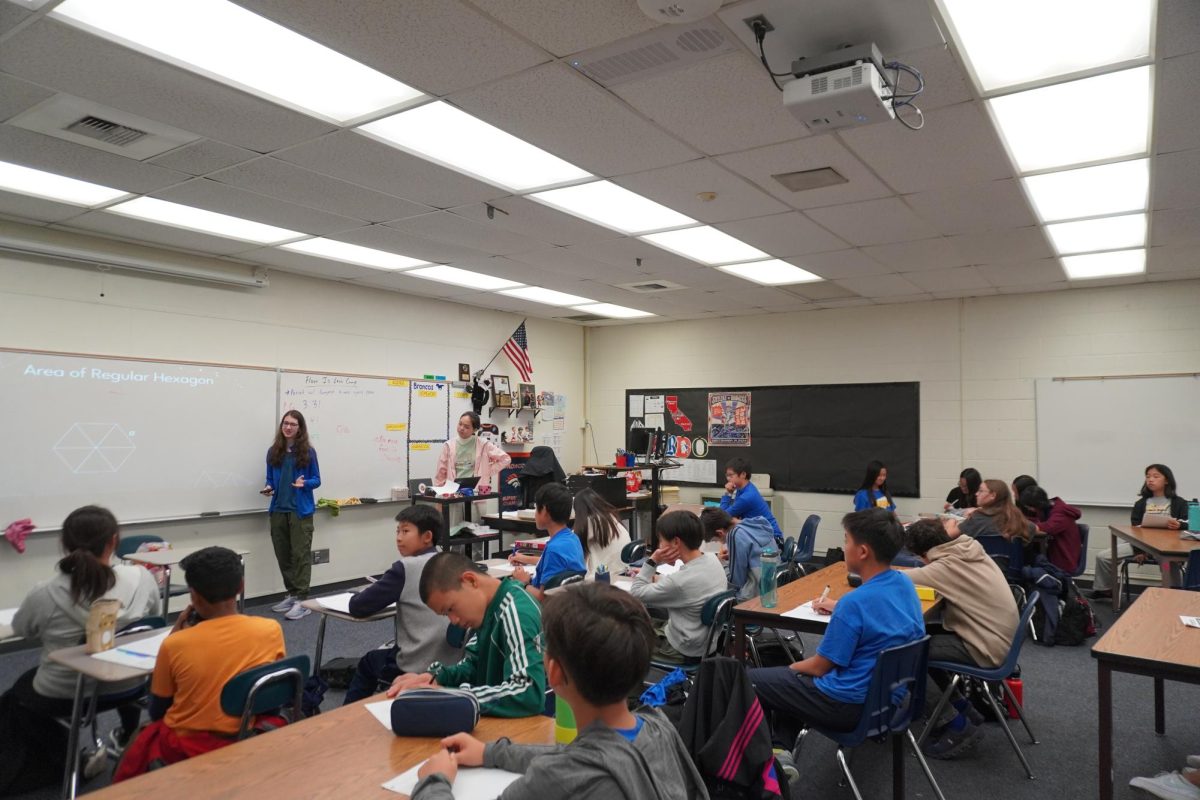 Sophomore Tori Porat and senior Minerva You demonstrate a geometry problem to students in the RSJMS MATHCOUNTS program. 