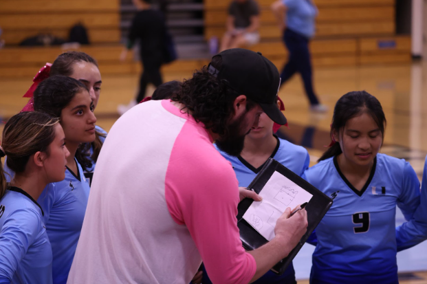 UHS Volleyball Head Coach Mike Sofly leading his team during their Senior Night game.