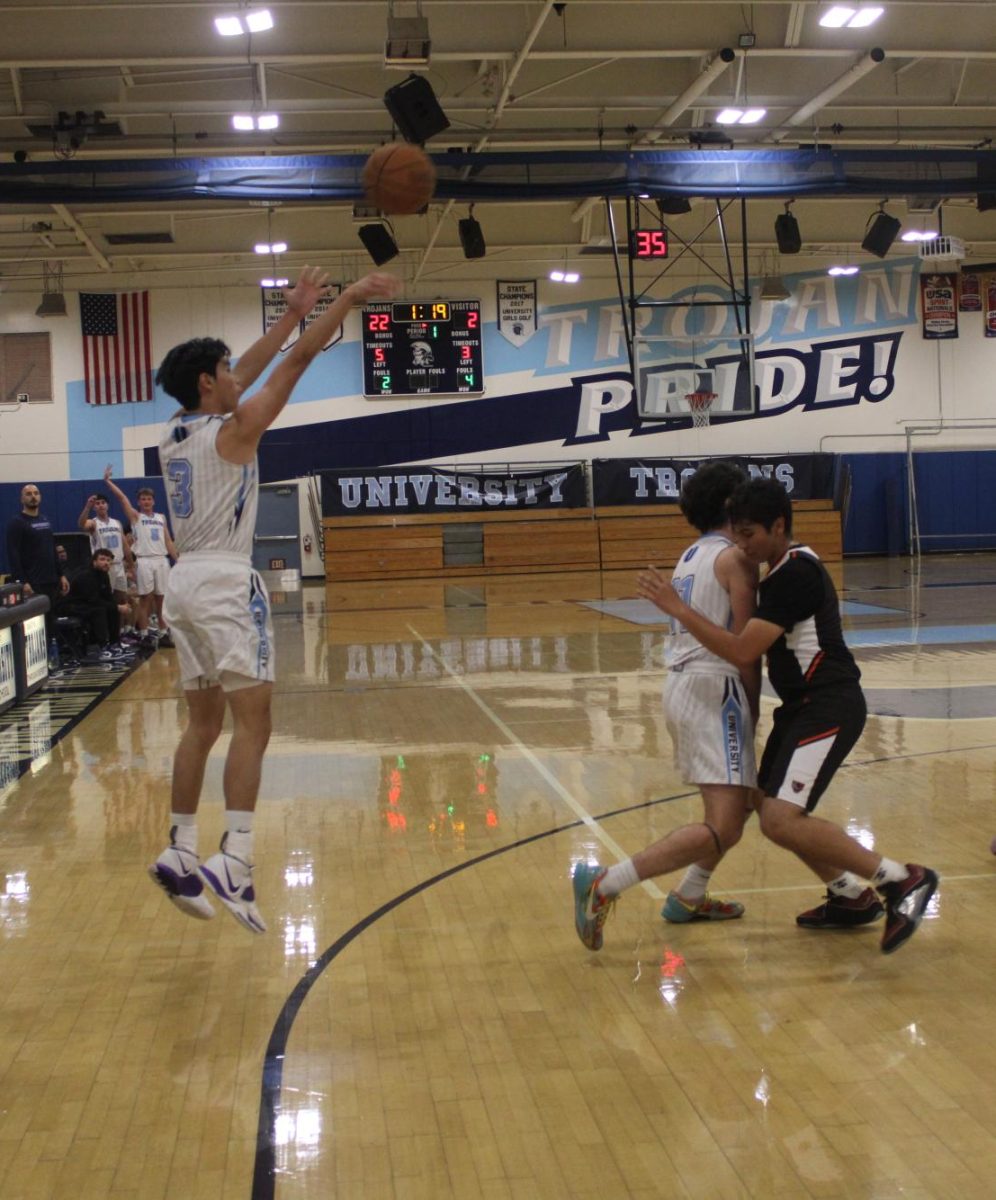 UHS Varsity Boys' Basketball player, Joshua Thio, shoots a three-pointer in their victory over the Orange Panthers.