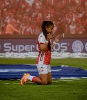 Praying before a soccer game is a common pre-game ritual, as seen with this women's soccer player.