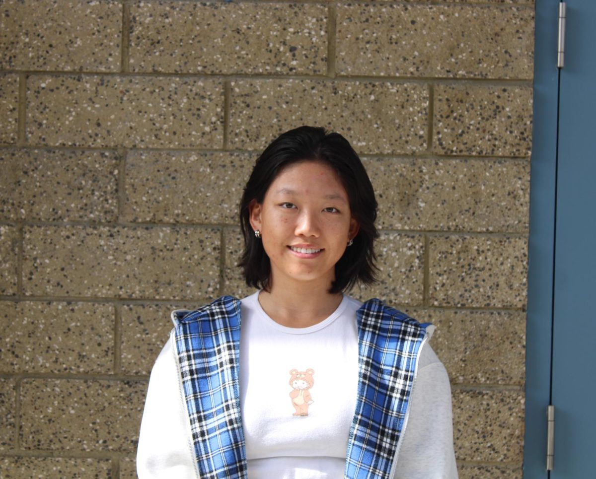 Varsity girls' golf athlete. Emma Zhao. poses for a photo.