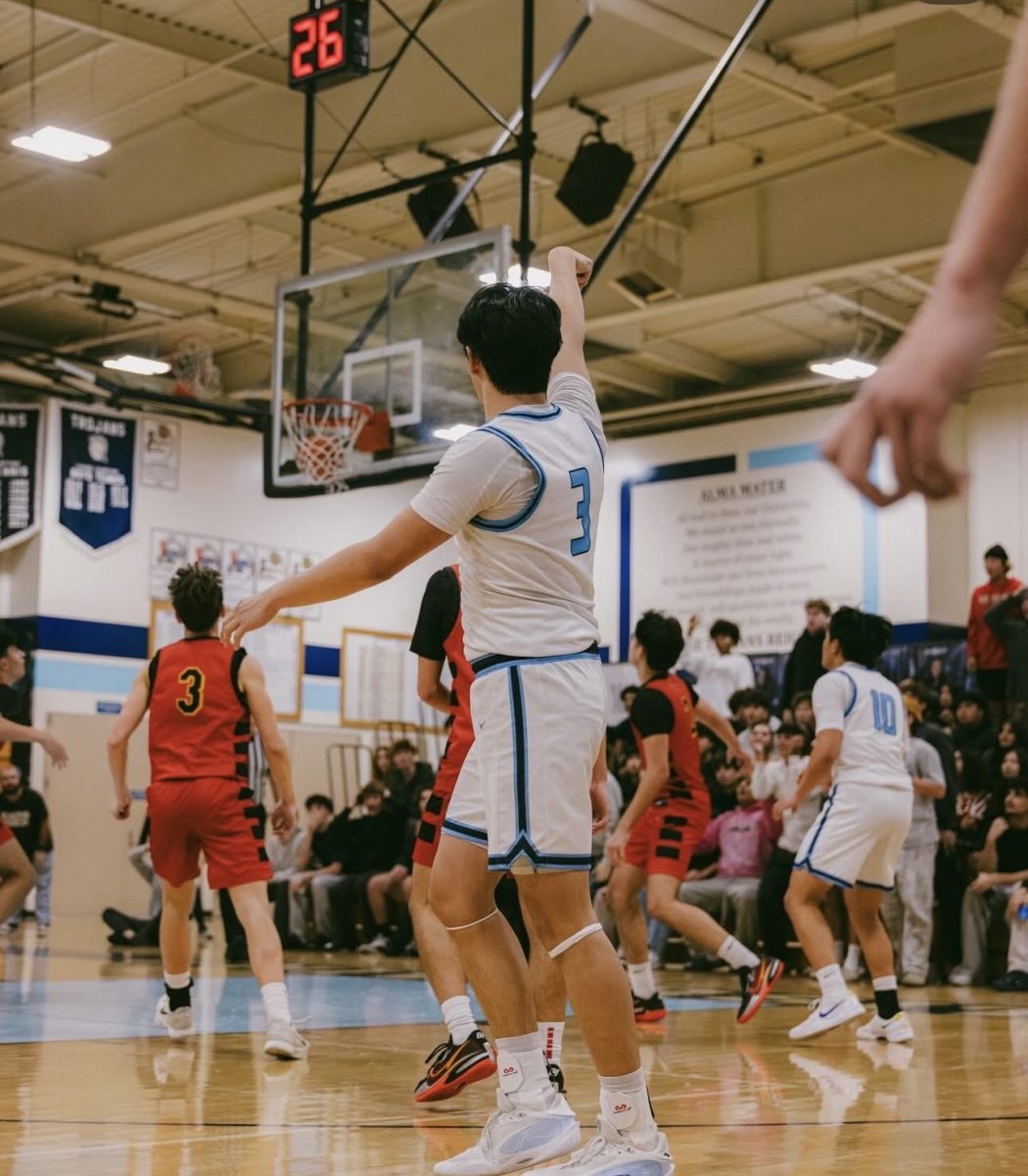 Senior captain Josh Thio knocks down a crucial three-point shot late in the fourth quarter to give the Trojans the lead.