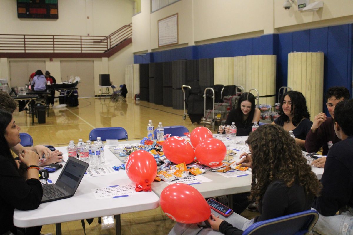 Blood Drive volunteers talk as they help with setup and running the event.
